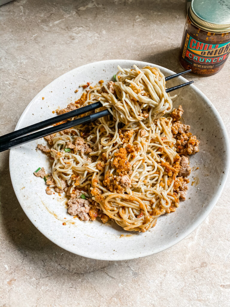 Finished bowl of Dan Dan Ramen Noodles with chopsticks. 