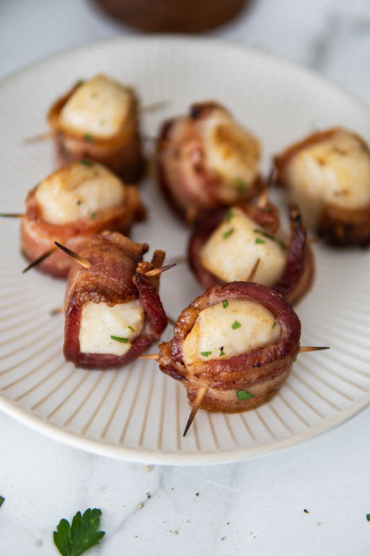 Smoked Bacon Wrapped Scallops on a plate.