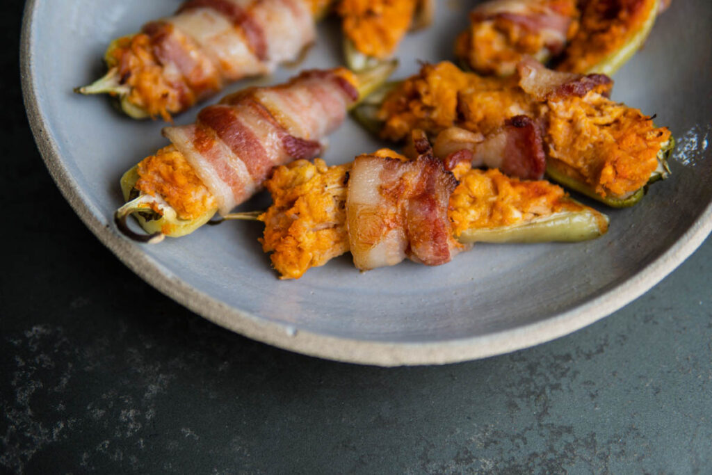 Plate of bacon wrapped banana peppers.