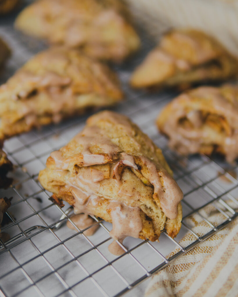Apple Pie Scones with Cinnamon Glaze on a cooling rack.