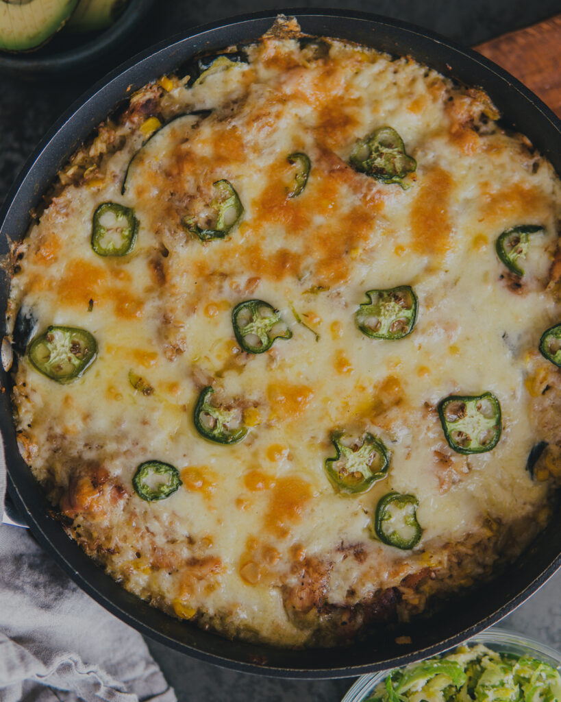 One pot skillet of Chicken & Rice Enchilada Bake hot from the oven.