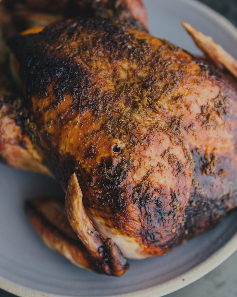 Whole roasted turkey on a serving plate.