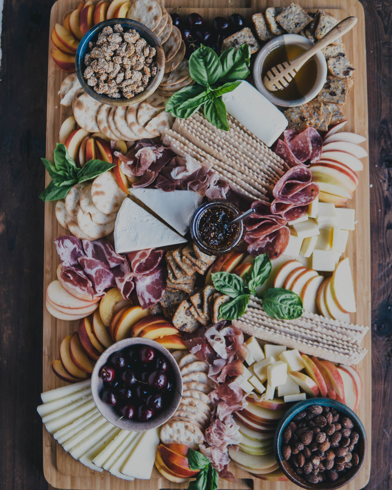 A beautiful Summer Charcuterie Board Spread on a wooden cutting board for this year's Labor Day Weekend Menu.