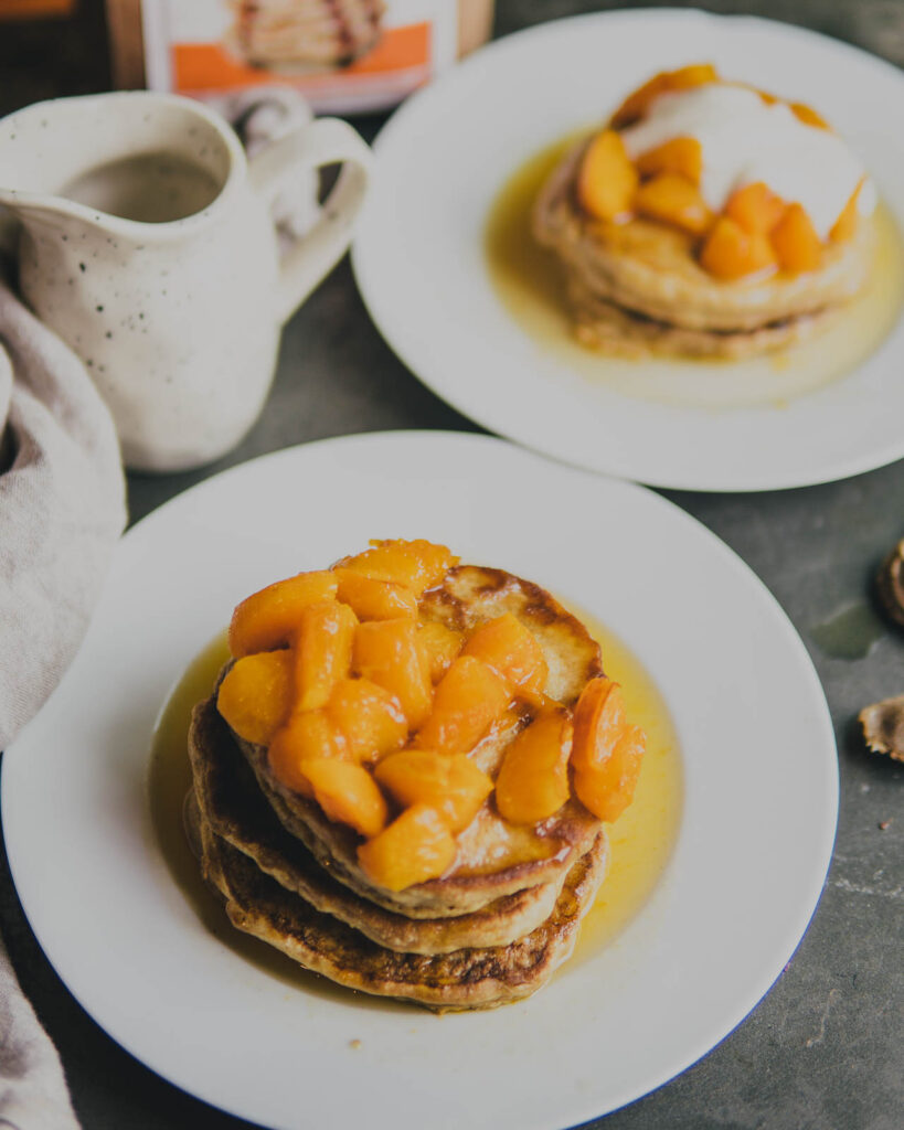 Maple glazed apricot pancakes with maple yogurt on a plate.