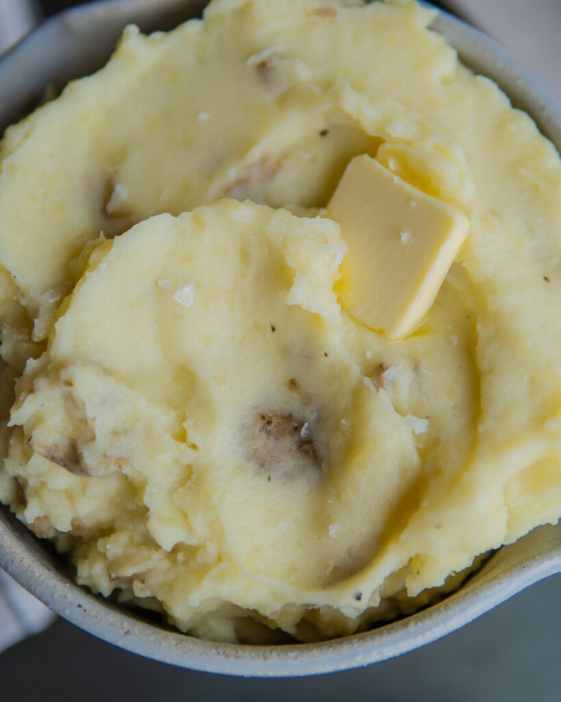 Pressure cooker mashed potatoes topped with a pat of butter. 