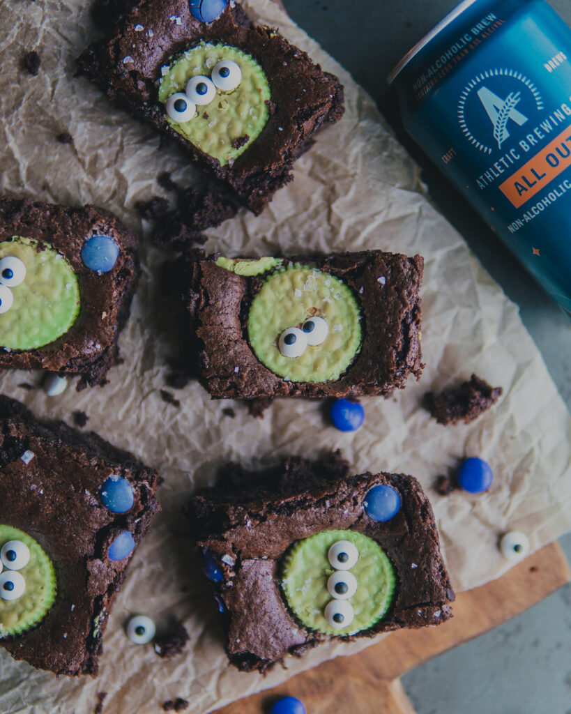 Little Green Men Beer Brownies cut up and next to a can of All Out Stout Athletic Brew Beer.