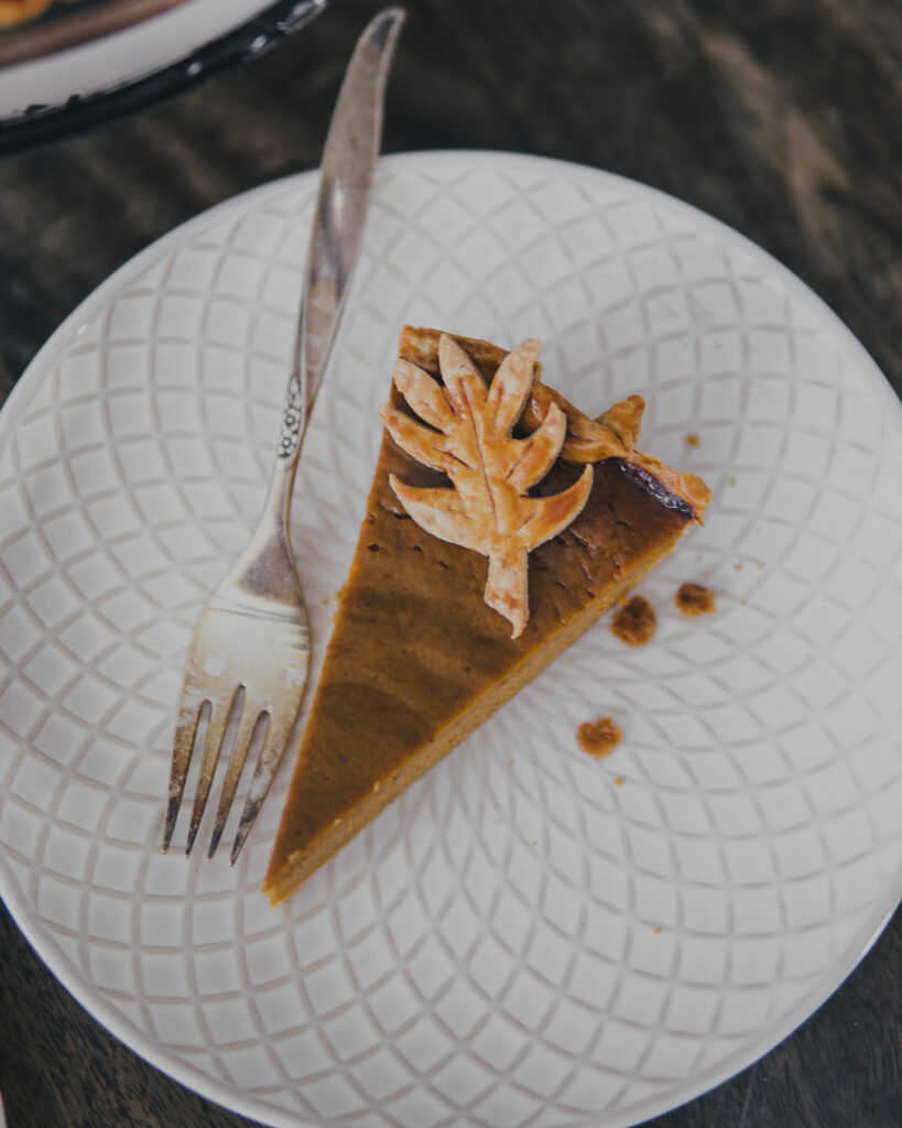 Slice of Smoked Pumpkin Pie on a plate with a fork. 